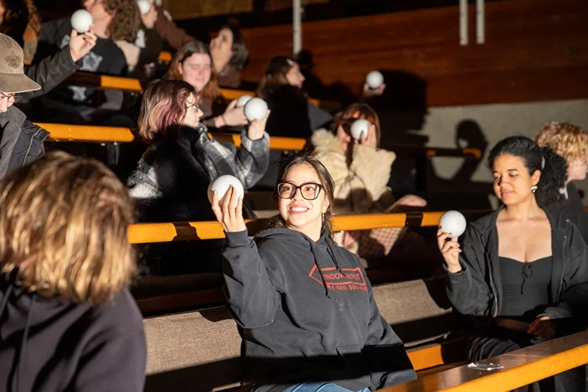 students hold up an object in an eclipse class