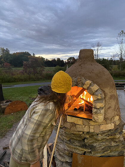 Image of student firing pizza