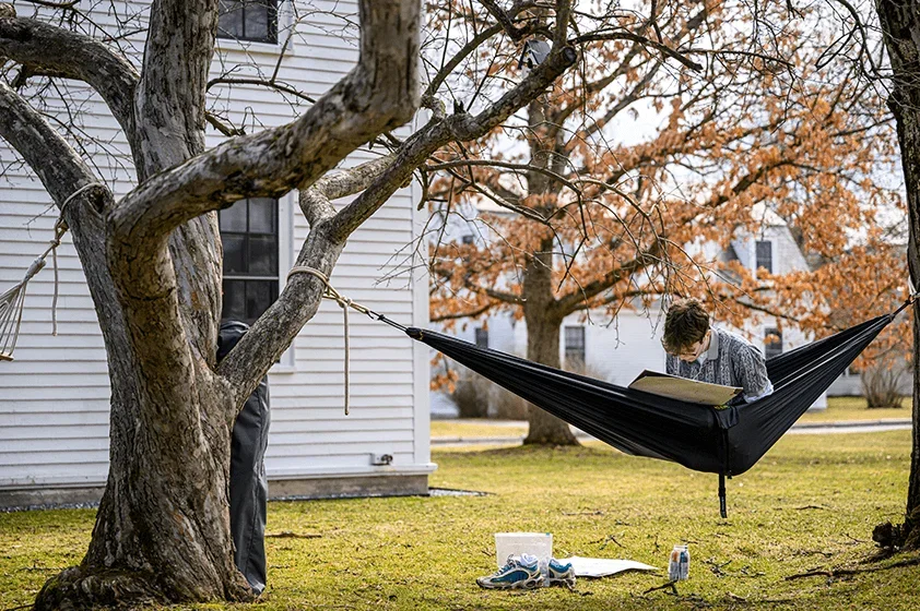a student reads in a hammock