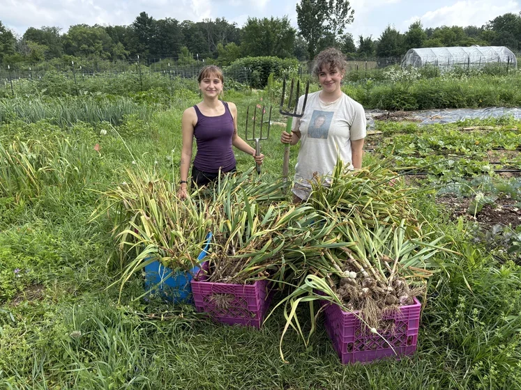 Students posing proudly with garlic harvest