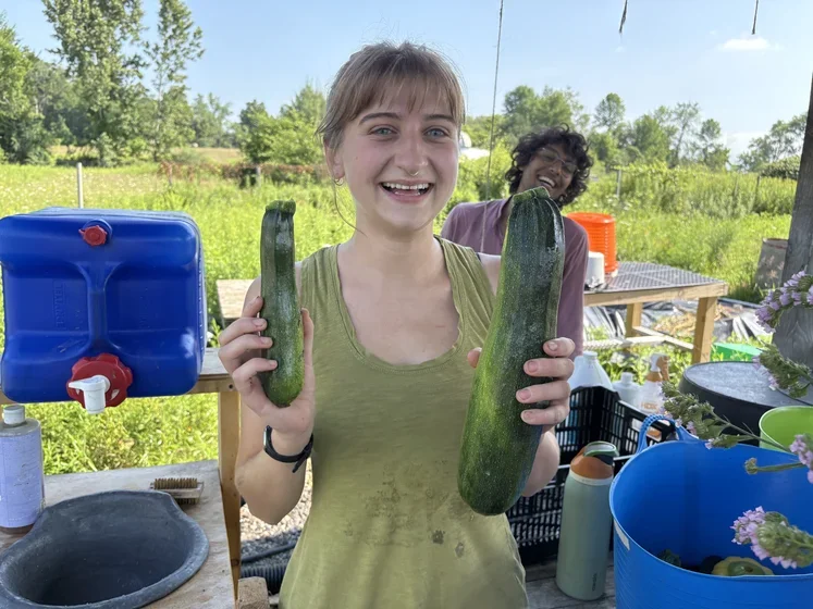 Student holding zucchini