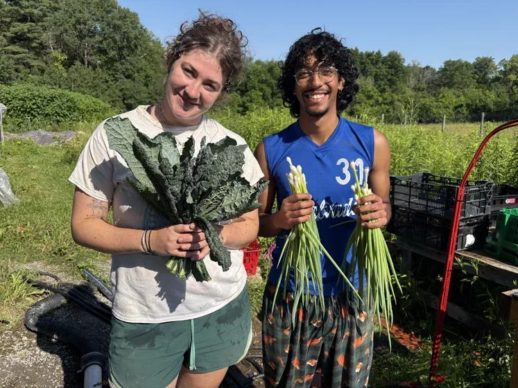 Two smiling students at Purple Carrot Farm