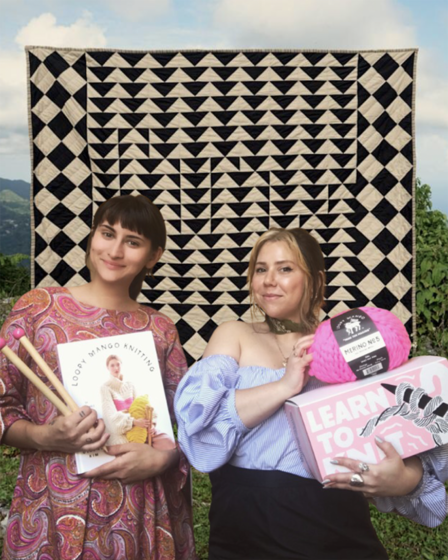 Image of two women in front of step and repeat