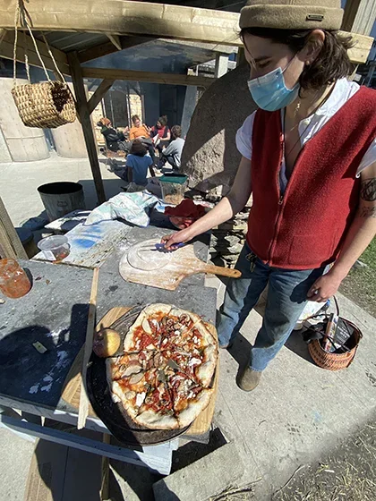 Image of student making pizza