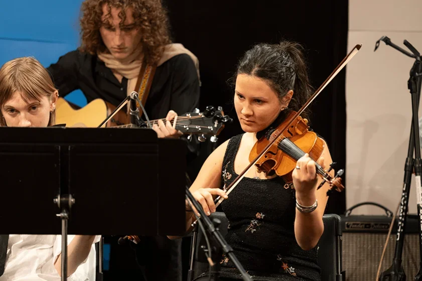 a student plays violin during a concert